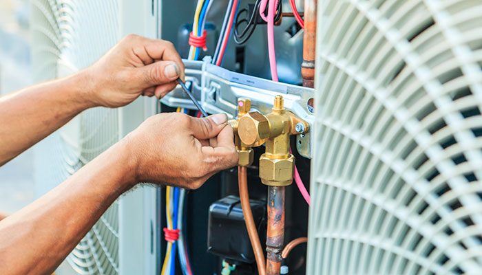 Close-up of AC refrigerant valve service work